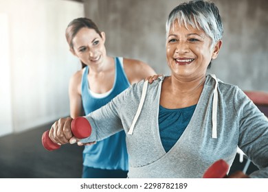 Physical therapy, dumbbell and fitness with old woman and personal trainer for support, health and physiotherapy. Training, weightlifting and coaching with senior patient and female trainer for help - Powered by Shutterstock