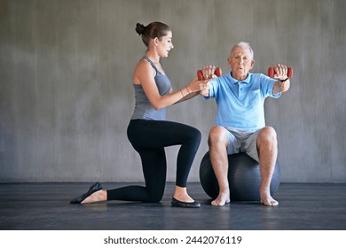 Physical therapy, dumbbells and senior man exercise on ball for fitness or rehabilitation at gym on mockup space. Elderly person, weightlifting and physiotherapist help for body health or wellness - Powered by Shutterstock