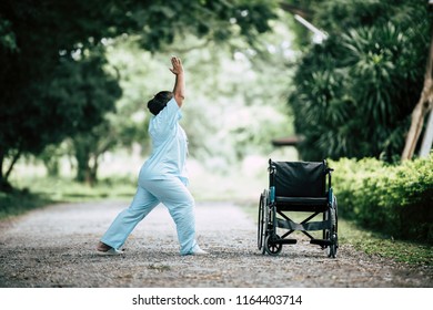 Physical therapy senior woman with wheelchair in the park - Powered by Shutterstock