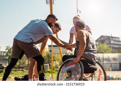 A physically challenged person plays street basketball with his friends.They making high five.	
 - Shutterstock ID 2151736923