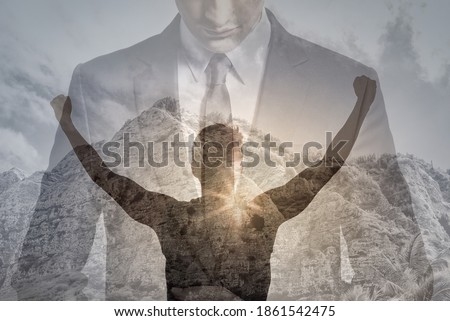Physically, and mentally strong young businessman man with fist in the air feeling victorious and motivated. double exposure. 