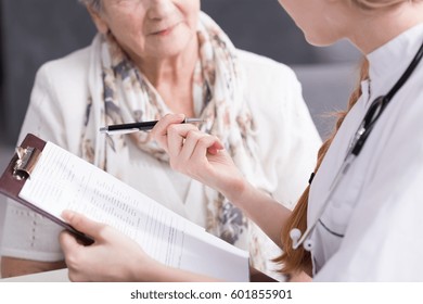 Physician Doing Medical Interview With Elderly Patient