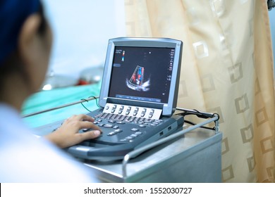 Physician making echocardiography for patient with heart disease