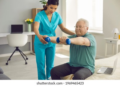 Physician, Physiotherapist Or Home Care Nurse Checks How Happy Old Male Patient Does Arm Exercise During Wellness Workout Practice. Providing Help, Physical Therapy And Senior Citizens Rehabilitation