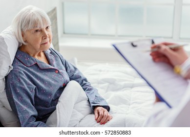 Physician Questioning Old Woman In Hospital