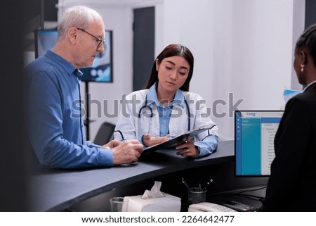 Physician showing disease diagnosis report to sick elderly patient discussing health care treatment in hospital waiting area. Medic prescribing medication to help manage the man chronic pain.