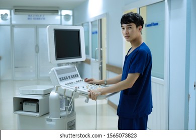 physician stand beside echocardiogram machine in cardiac center 