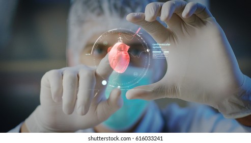 A physician, surgeon, examines a technological digital holographic plate represented the patient's body, the heart lungs, muscles, bones. Concept: Futuristic medicine, world assistance, and the future