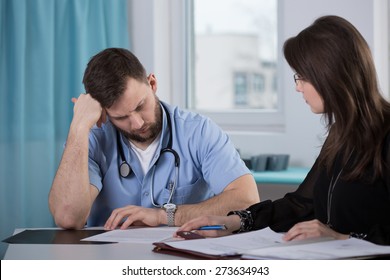 Physician who commit medical error talking with lawyer