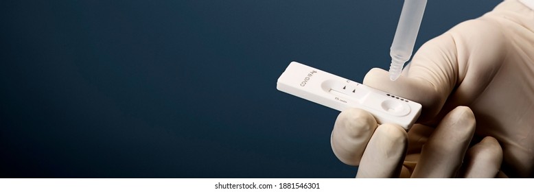 Physician who owns a COVID-19 antigen test kit with a COVID-19 2019-nCoV viral disease test kit. SARS-CoV-2 coronavirus virus lab card kit test. Rapid COVID-19 test - Shutterstock ID 1881546301