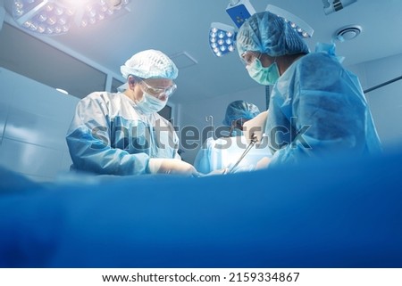 Physicians doing surgery work in operation theater