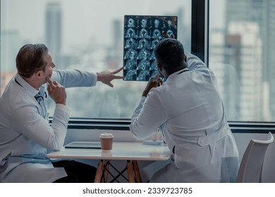 Physicians spend break time analyzing medical images, including MRI films of patient conditions, in order to develop treatment plans and future medical procedures and refer patients to specialists.
