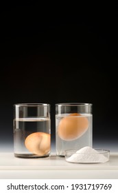 Physics. Water density science experiment. Egg floating in salt water.Black background. - Shutterstock ID 1931719769