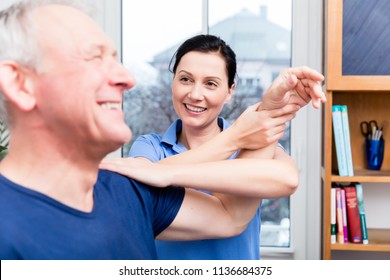 Physio Doing Shoulder Exercises With Senior Man