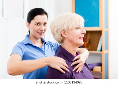 Physio giving shoulder massage to patient - Powered by Shutterstock