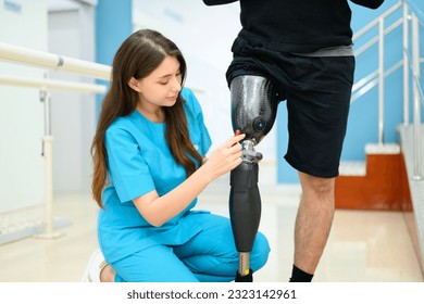 Physiotherapist adjusting prosthetic leg of patient in hospital - Powered by Shutterstock