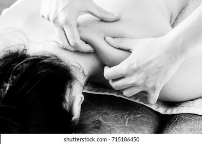 Physiotherapist, Chiropractor Giving A Massage And Stretching Of Subscapularis And Rhomboid To A Patient  In Silhouette Isolated On White Background.