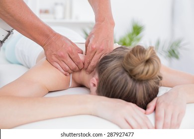 Physiotherapist doing arm massage to his patient in medical office