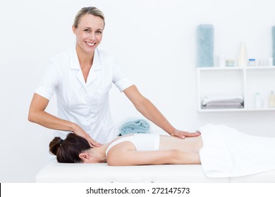 Physiotherapist Doing Back Massage In Medical Office