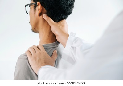 Physiotherapist doing healing treatment on man's neck,Chiropractic adjustment, pain relief concept.office syndrome - Powered by Shutterstock