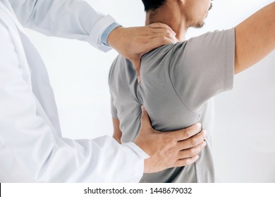 Physiotherapist doing healing treatment on man's back.Back pain patient, treatment, medical doctor, massage therapist.office syndrome - Powered by Shutterstock