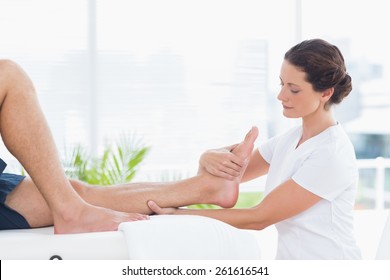 Physiotherapist Doing Leg Massage In Medical Office