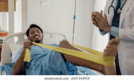 Physiotherapist doing physical therapy on male patient with leg muscle injury in nursing department: healthy medical therapy concept. Professional male therapist working in rehabilitation center - Powered by Shutterstock