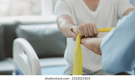 Physiotherapist is doing physical therapy for a patient, the patient has body aches due to overwork and has undergone treatment and physiotherapy with a professional physiotherapist. - Powered by Shutterstock