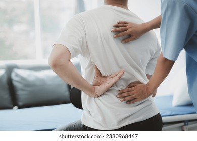 Physiotherapist doing physiotherapy for patient in a hospital room, physiotherapy helps to recover from illness by moving the body and muscles. The concept of treating illnesses with physical therapy. - Powered by Shutterstock