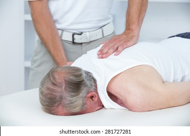 Physiotherapist doing shoulder massage to his patient in medical office - Shutterstock ID 281727281