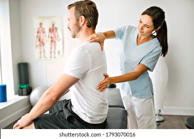 A physiotherapist doing treatment with patient in bright office - Shutterstock ID 1793070016