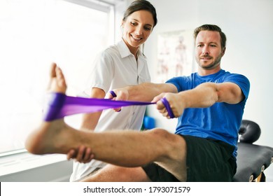 A physiotherapist doing treatment with patient in bright office