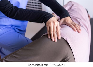 Physiotherapist doing treatment to senior woman patient in clinic ,Elderly women suffering from low-back lumbar pain,Physical therapy concept - Powered by Shutterstock