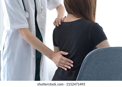 Physiotherapist Examining Female Patient With Back Injuries. Physical Therapy Concept.