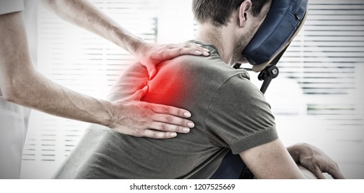 Physiotherapist giving massage to man against highlighted pain