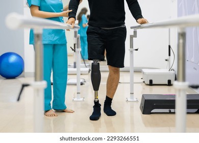 Physiotherapist helping patient with prosthetic leg at parallel bars - Powered by Shutterstock