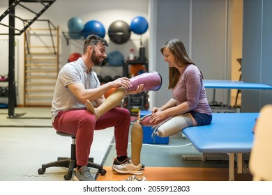 Physiotherapist helping young woman with prosthetic legs
 - Powered by Shutterstock