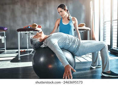 Physiotherapist, injury and elderly woman with ball in clinic for rehabilitation, support or stretching. Workout, healthcare worker and senior patient for balance, recovery help or physical therapy - Powered by Shutterstock