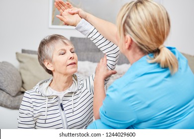 Physiotherapist Makes Occupational Therapy Exercise With Senior Citizen