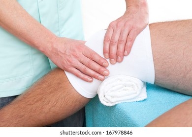 Physiotherapist making a massage of injured patient's knee joint - Powered by Shutterstock