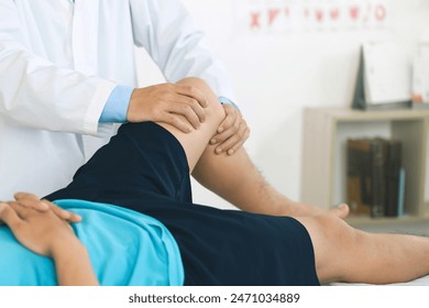 physiotherapist massaging the knee of a patient. rehabilitation and recovery after physical knee injuries.Rehabilitation physiotherapy. Sportsman Recovering from Injury, Undergoing Rehabilitation. - Powered by Shutterstock