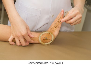 Physiotherapist Measuring Range Of Motion Patients' Wrist With Goniometer