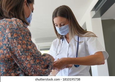 Physiotherapist With Patient, Wearing Face Mask