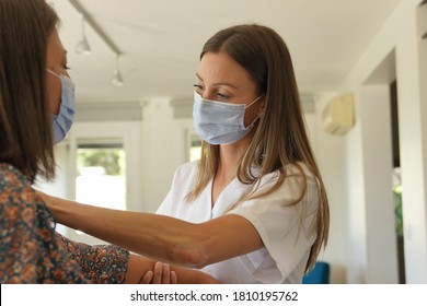 Physiotherapist With Patient, Wearing Face Mask