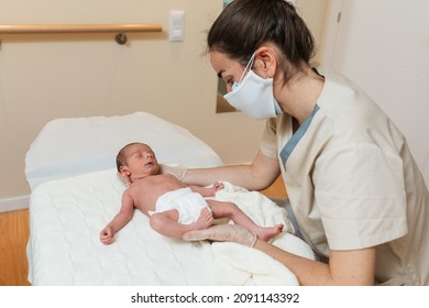 Physiotherapist performing craniosacral work on a newborn baby.