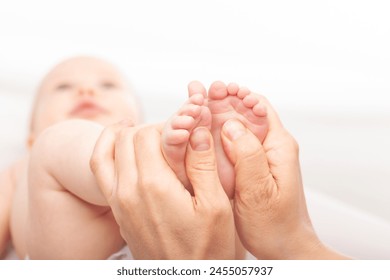 Physiotherapist performing massage on infant's feet - Powered by Shutterstock