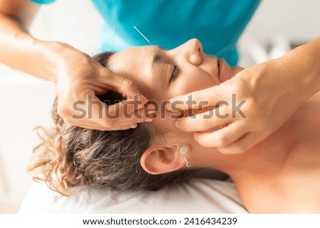 Similar – Image, Stock Photo A physiotherapist performs a facial acupuncture session on her patient to tone the muscles of the face