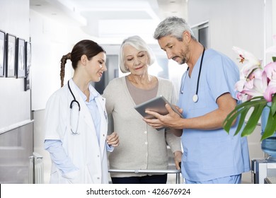 Physiotherapist Showing Reports To Patient And Doctor On Digital - Powered by Shutterstock