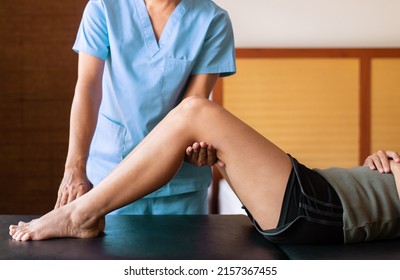 Physiotherapist training treatment to woman patient at home,Physical therapy concept - Shutterstock ID 2157367455