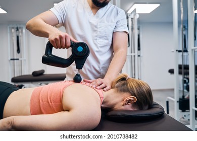 Physiotherapist Treats Woman Spine And Back With Massaging Percussion Device. Physio Therapy